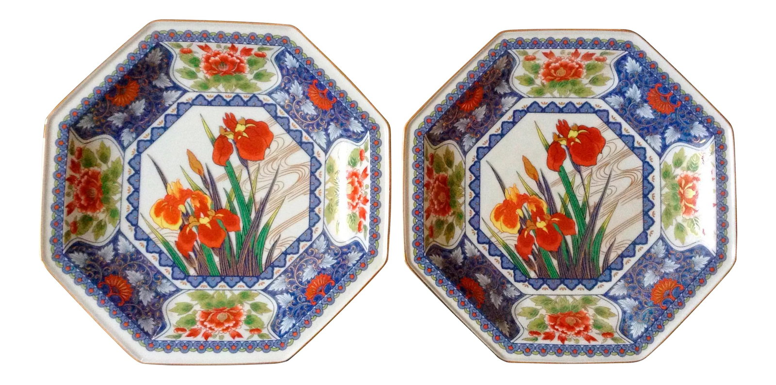 Japanese Octagon Plates - A Pair: This pair of Japanese plates are beautifully decorated with central irises in bloom and a heavily decorated blue surround including red peonies. Maker's mark on the back. Condition: Alterations: Origi