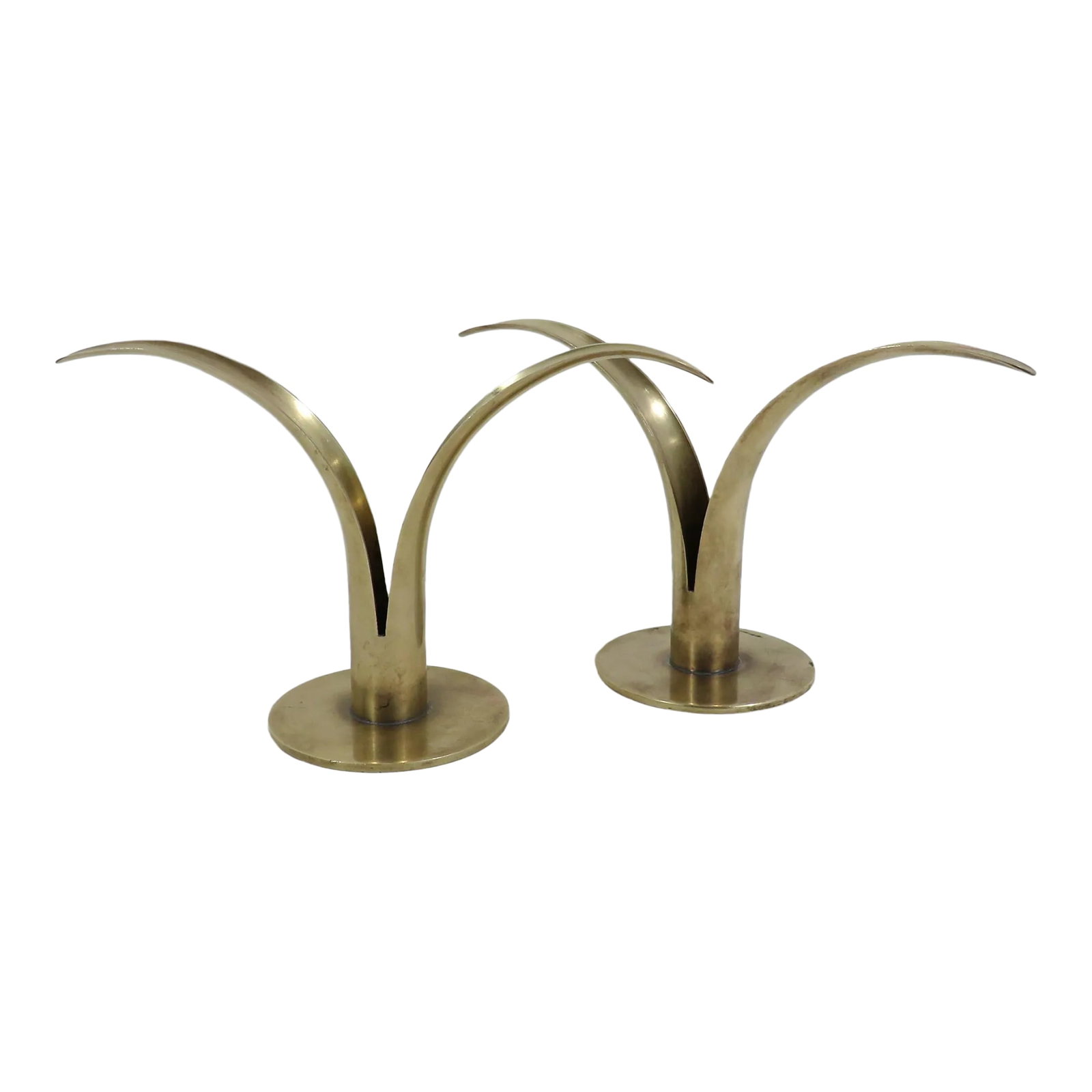 Swedish Brass Lily Candlesticks, a Pair: A pair of vintage Swedish brass candlesticks in iconic lily design, originally created by Ivar Alenius Bjork (1905 - 1978) for Ystad-Metall. Since its closing in 1969, several other companies have