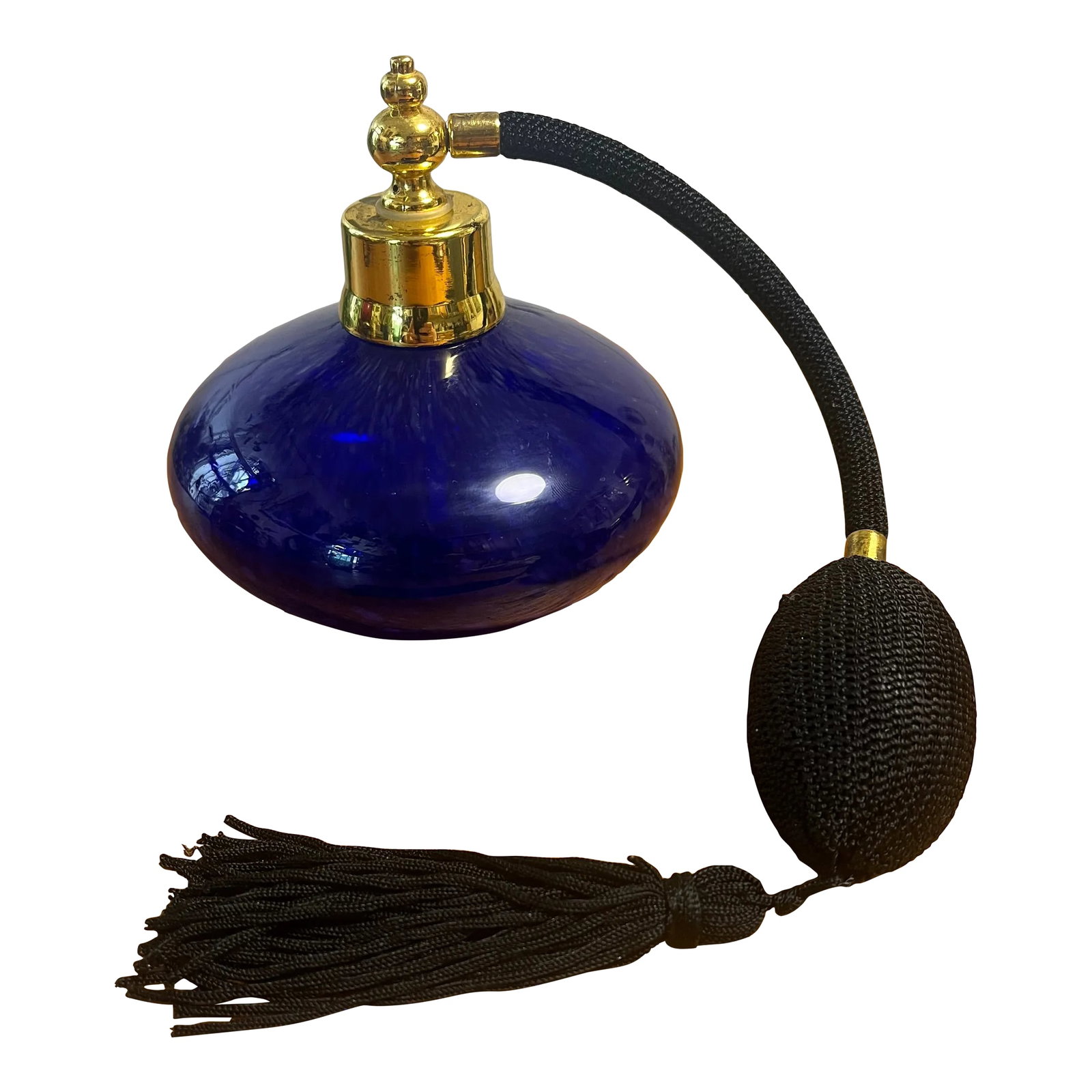 Vintage Cobalt Blue Art Glass Perfume Bottle With Gold Accents & Black Atomizer: Cobalt Blue Art Glass Perfume Bottle round shape With Gold Accents & Black Atomizer Some fraying in atomizer & tassel fabric Discoloration in aged gold metal 4"x4"x4" Tassel/atomizer 11" long outstret