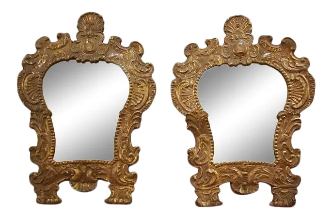 Mid 19th Century Petite Repousse Rococo Mirrors - a Pair: A pair of small 19c. mirrors in cartouche shaped, rococo frames, the glass patinated, and the backs of wood. Condition: Alterations: Original Condition Unaltered Imperfections: Some Imperfections Cond