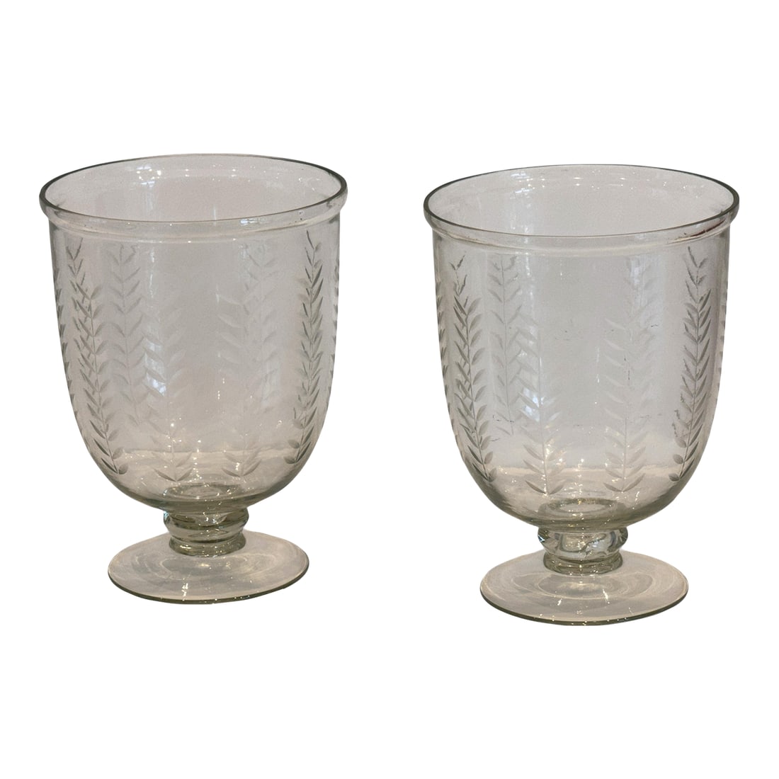 Pair of Etched Glass Vases With Wheat Design: Pair of clear glass vases etched with a repeating wheat motif. Each has a rounded form that tapers to a simple circular foot. A graceful design suitable for tabletop display or floral arrangements.