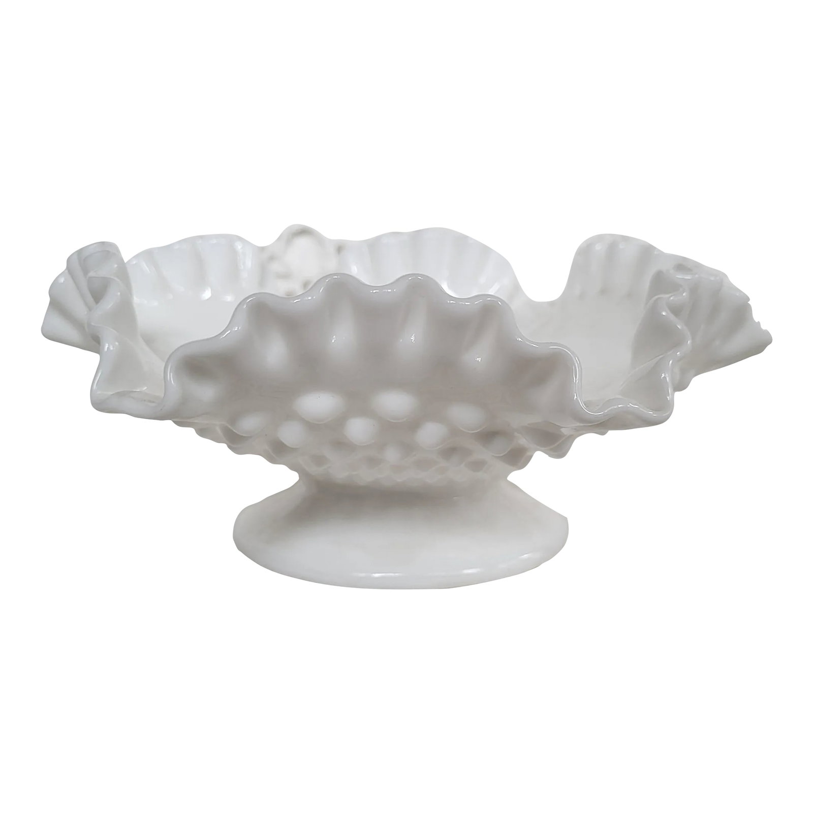 1960s Fenton Footed Milk Glass Bowl: A Fenton hobnail milk glass footed ruffled bowl just the right size for holding a bowl of lemons! It measures 8" x 3 1/2" x 2 1/4" base. Condition: Alterations: Original Condition Unaltered