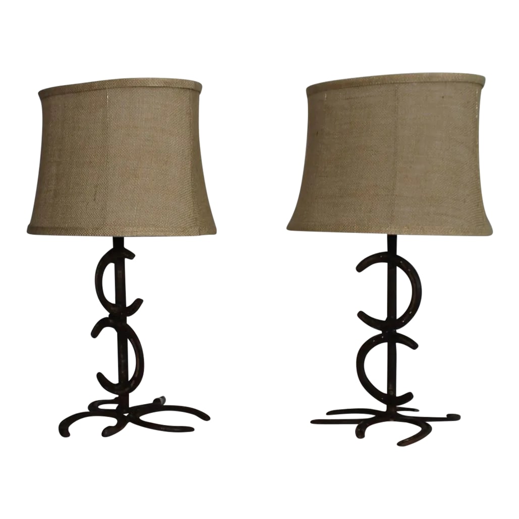 1930s Rustic Wrought Iron Horse Shoe Lamps - a Pair: A Unusual pair of horse shoe lamps. Made from seasoned wrought iron shoes. Vibrant rust color. luck abounds. Frederic Remington in style. Sculptural presence. Can work in a rustic setting such as