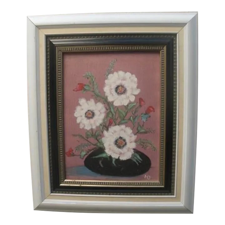 Mid 20th Century Modern Floral Still Life Painting: There is something absolutely charming about this wonderful floral still life. The muted dusty rose background really make the black vase, red flowers, and white blooms pop, along with the flecks of g