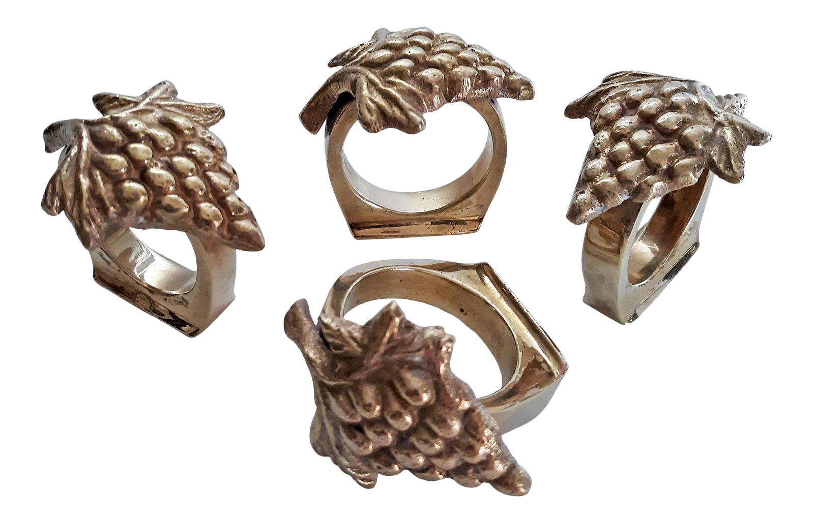 Vintage Solid Brass Grape Vineyard Motif Napkin Rings - Set of 4: Set of 4 vintage solid brass napkin rings with vineyard motif. Each napkin ring features a cluster of grapes with leaves. These are well balanced; made of heavy solid brass and have a wide, flat base 