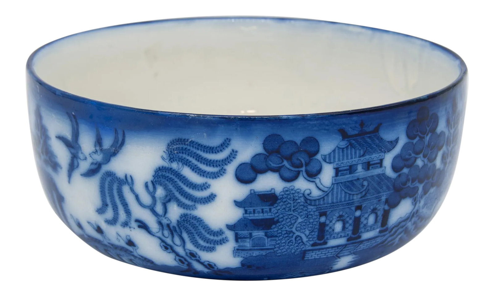Early 20th Century Willow Flow Blue Bowl: Decorative willow flow blue bowl. This design featured pagodas, trees, and birds. Flow blue is a style popular in Regency England that gets its name from the blue glaze applied, which gives the appear