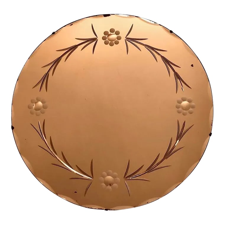 1930s Art Deco Peach Etched Circular Beveled Wall Mirror: Scalloped beveled edge and etched garland of leaves and flowers decorate this Art Deco style mirror. The peach color gives the most flattering warm glow to anyone looking into it and would look