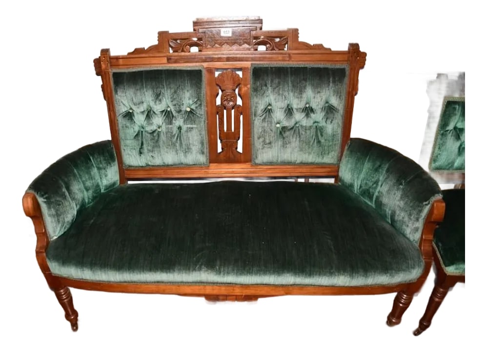 Antique Eastlake Victorian Loveseat: A handsome 19th-century Eastlake Victorian chair, upholstered in a rich forest-green velvet. Crafted from solid wood-likely mahogany-it features finely executed, hand-carved detailing characteristic o