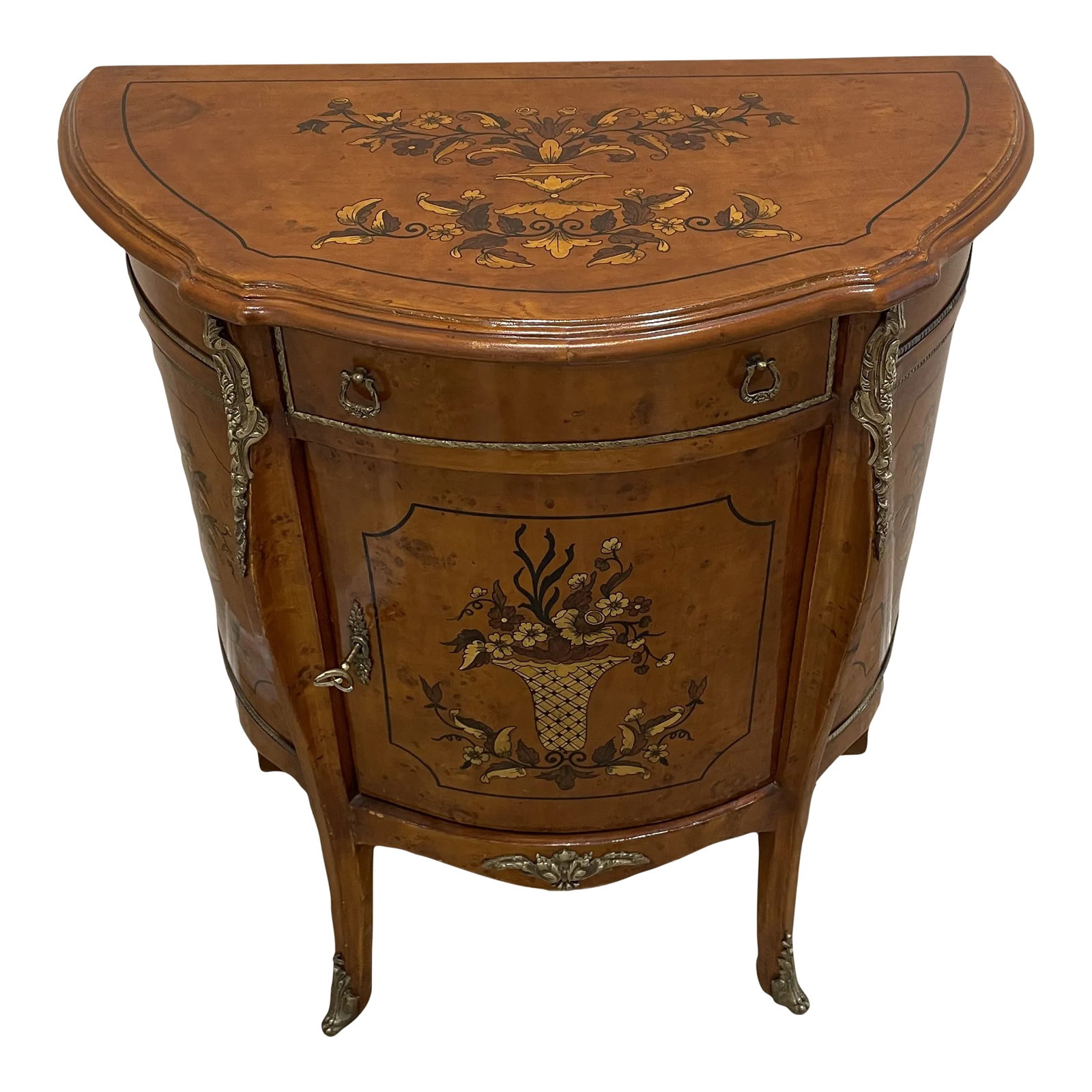 1990s Demi-Lune Accent Cabinet Italian Neoclassical Style Faux Marquetry: Italian neoclassical style accent cabinet. The lovely faux marquetry depicts a basket with flowers on the front of this demi-lune cabinet ideal for tight spaces. In a small bathroom or against a wall