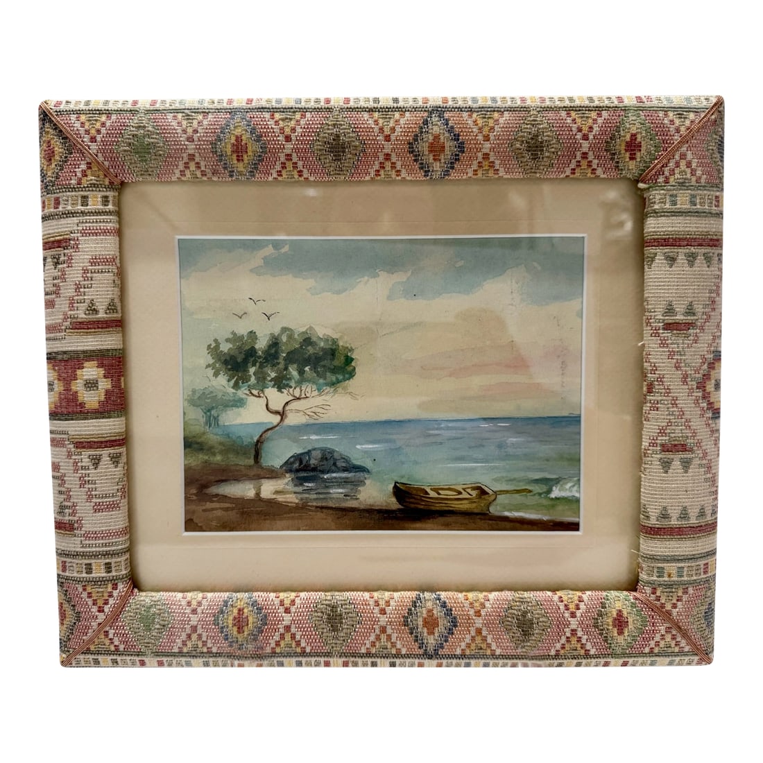 Mid 20th Century Coastal Landscape Watercolor Painting Framed Seascape Boat Tree: Antique watercolor coastal landscape featuring a shoreline scene with a tree, small boat, rocks, water, and birds in the sky. Presented under glass with a wide mat and patterned textile-style frame. D