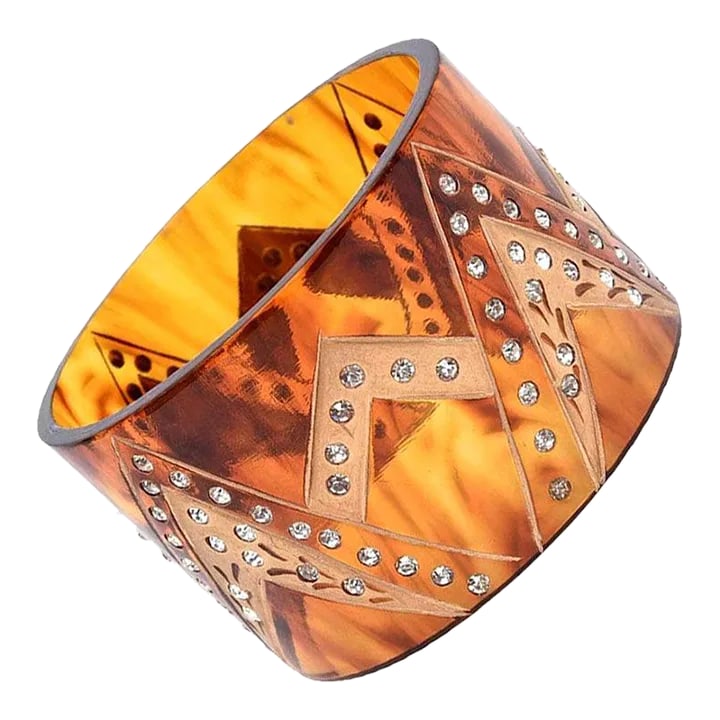 1980's French Tortoise Resin and Rhinestone Wide Cuff Bracelet: This is part of Chairish's Fine Jewelry assortment. This French wide cuff bracelet has inverted V's with gold applied and rhinestones adorning the v patterns.. It is amber colored tortoise resin. It