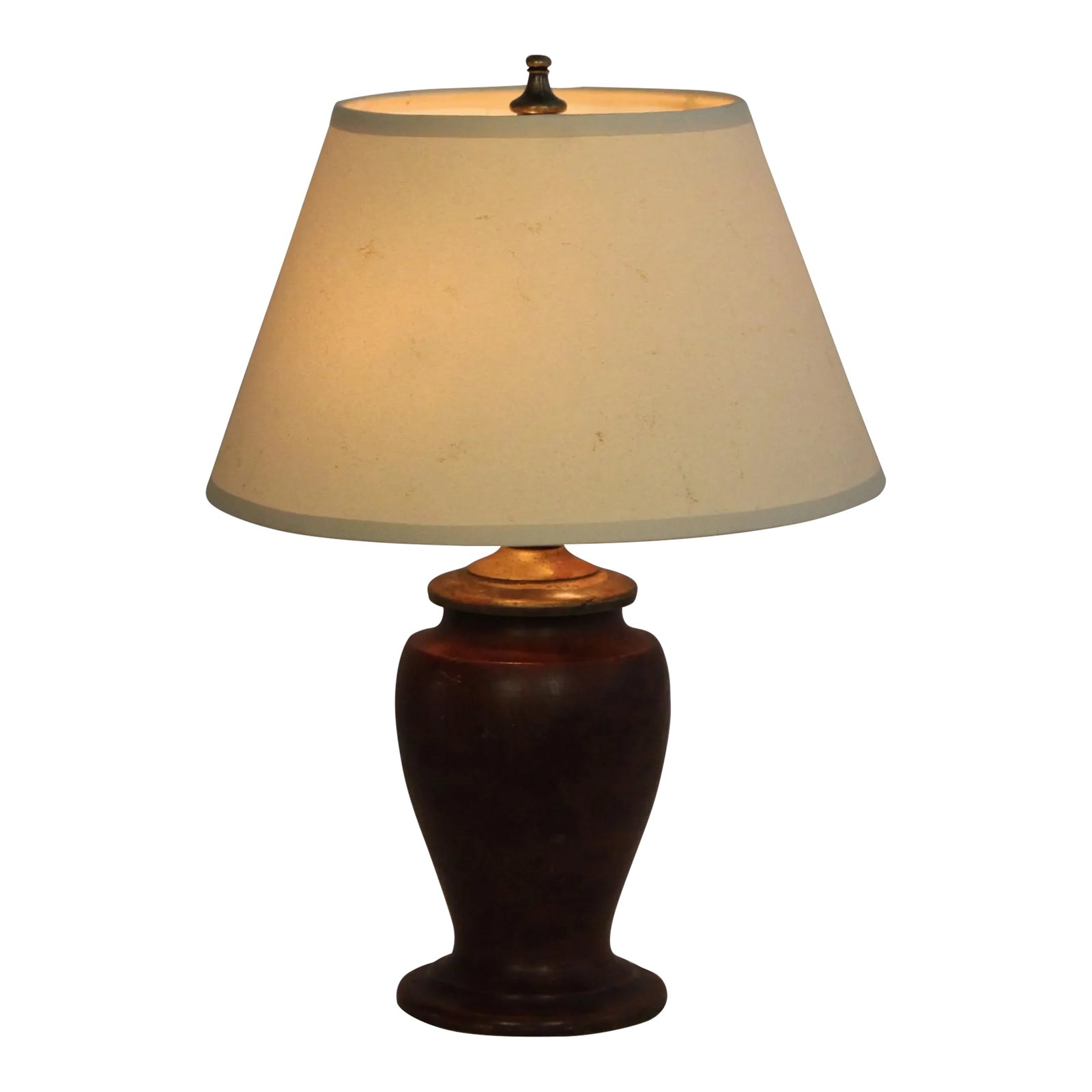 1930s Petite Burled Mahogany Turned Lamp: Petite regency table lamp. Rich burled mahogany finish. Turned shape gives this piece a refined look. Vained parchment shade that emits a soft golden glow. Dimensions are 8 inches tall. 4 inches at