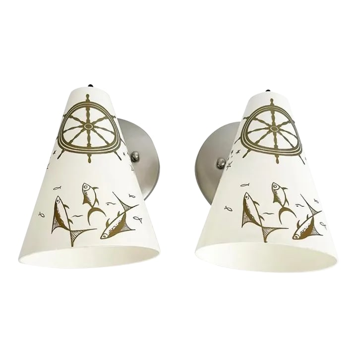 Midcentury Coastal Cone Sconces - A Pair: Fresh and fun pair of 1960s coastal style wall sconces of molded creamy white resin painted with central matte gold ships wheels, stars and schools of fish that pivot up and down. This pair is new