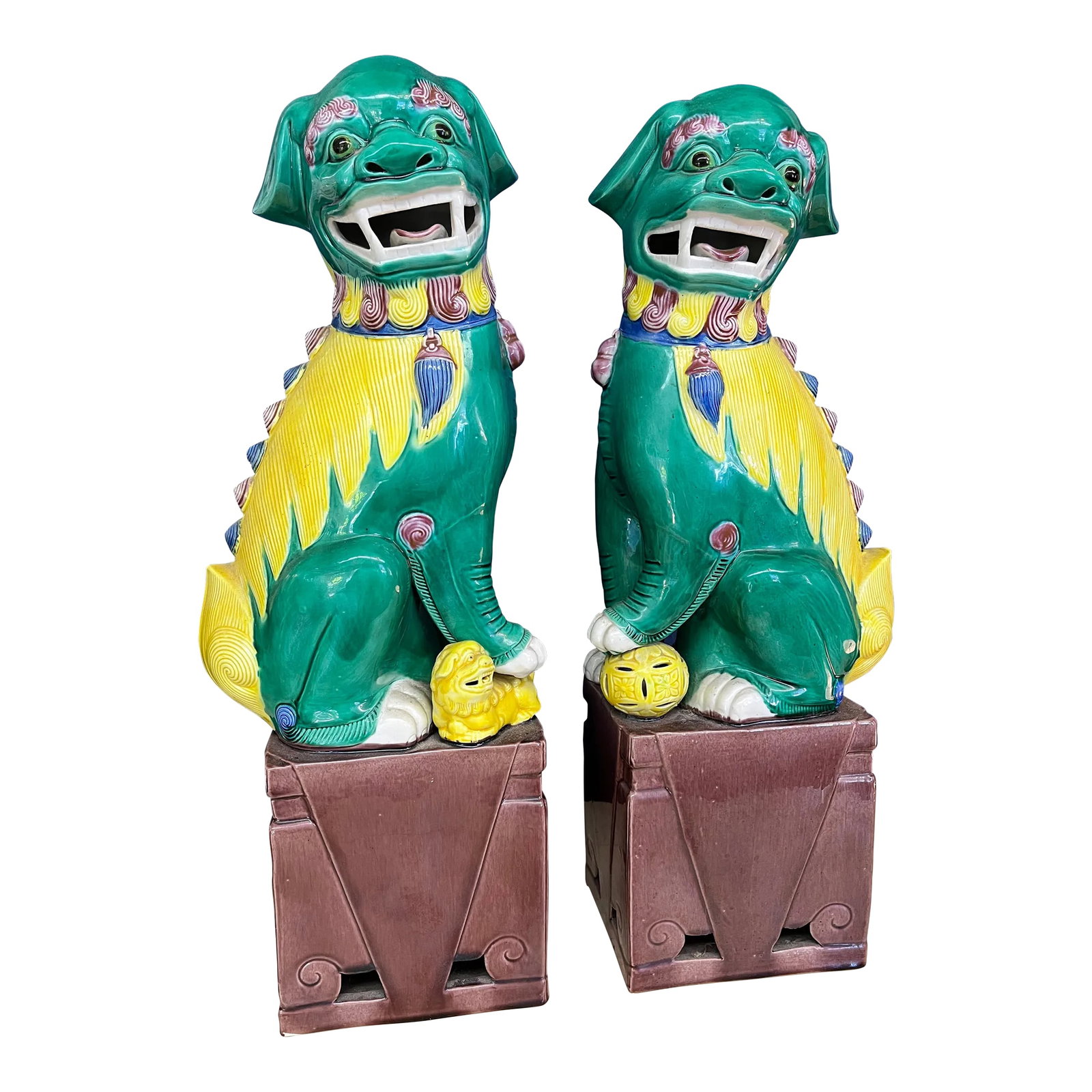 1970s Large Foo Dogs With Colorful Spirits, a Pair: Adorable Foo Dogs from the 1970's brought from Asia. The ball and baby symbolize protection of the home. These foos have cute smiles! Great for curating any space and adding the perfect touch of