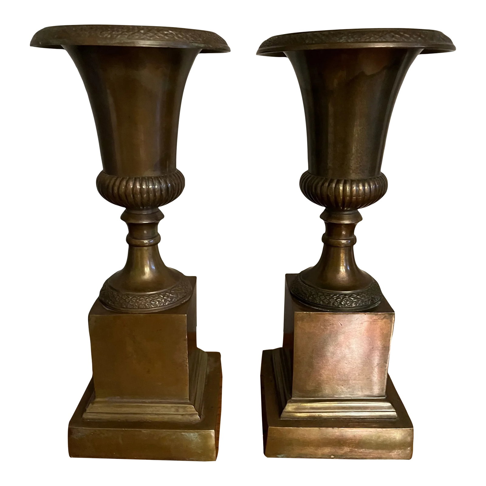 Solid Antique Brass Urns, Smaller Scale on Plinth Pedestals: This pair of urns are early 20th century with a beautiful patina. The urns themselves measure 4" deep which makes them perfect for miniature orchids, succulents, ferns or herbs. Condition:
