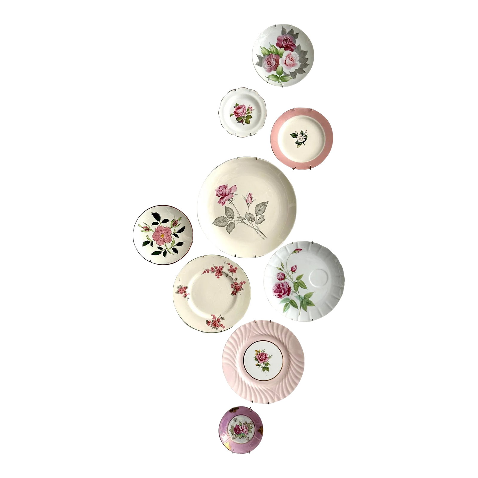Vintage Soft Pink Floral Motif Wall Plate Curation - Group of 9: Mixed rose pink and white decorative plates, group of 9. This beautiful set of decorative plates comes in a variety of designs and sizes with an overall rose pink, white, and floral colorway. Smallest