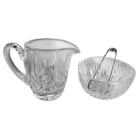 Waterford Crystal Ensemble - Set of 3: Three-Piece crystal creamer and sugar with silverplate sugar tongs. Maker's mark reads "Waterford, Holmes & Edwards (tongs)." Dimensions: Creamer, 5"L x 2.6'W x 4"H Sugar, 4"Dia x 2"H Tongs, 4.5"L x 1