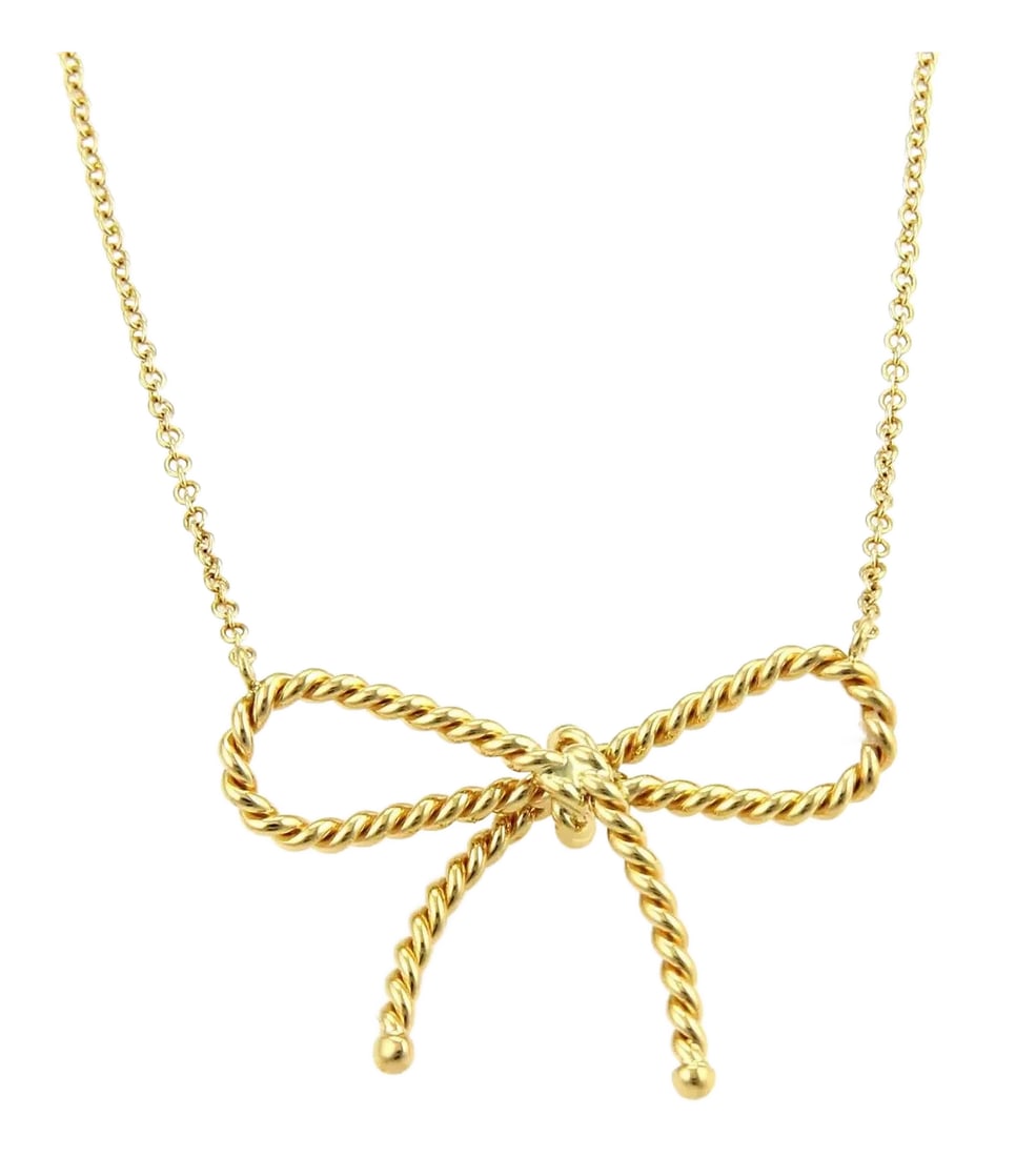 Tiffany & Co. Twisted Cable Wire 18k Yellow Gold Bow Pendant Necklace: Elegant and lovely cable wire bow pendant and chain necklace from the house of Tiffany & Co. It is crafted from solid 18k yellow gold with a fine polished finish, featuring a slim twisted wire style