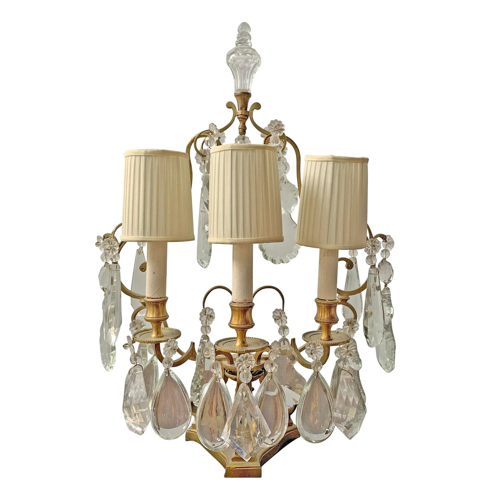 Early 20th Century French Girandole: A wonderful early 20th century French gilt bronze three-light girandole with pleated silk shades, and dripping with hand-cut rock crystal and man-made crystal pendalogues. Fixture is three sided, and 