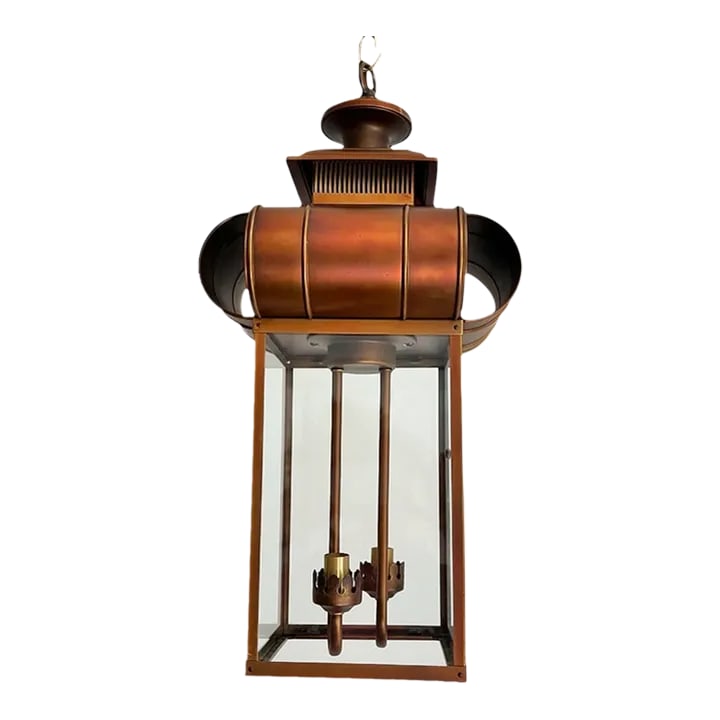 1960s Lantern Light by Moe: Tall 1960s Moe lantern light of warm coppery bronze in an elongated square metal frame with glass panels topped by a layered turret style finial with large rounded open fins and two suspended lights.