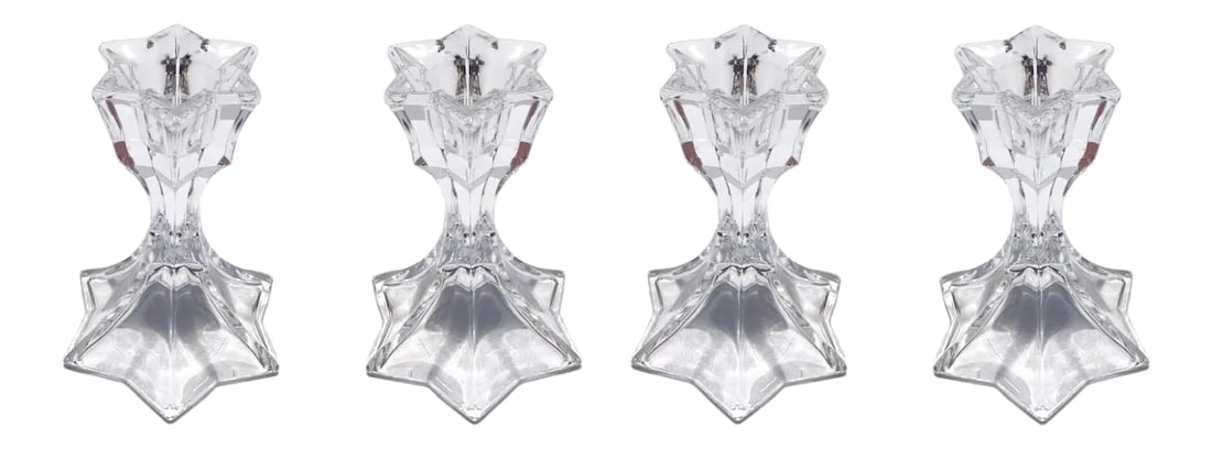 Set of Four Petite Vintage Faceted Crystal Candle Holders, 1970's: Elegant set of mid-century modern faceted lead crystal candle holders with six point star formation along the top. Candlesticks have stylized floral form resembling a lily or an iris flower along the 