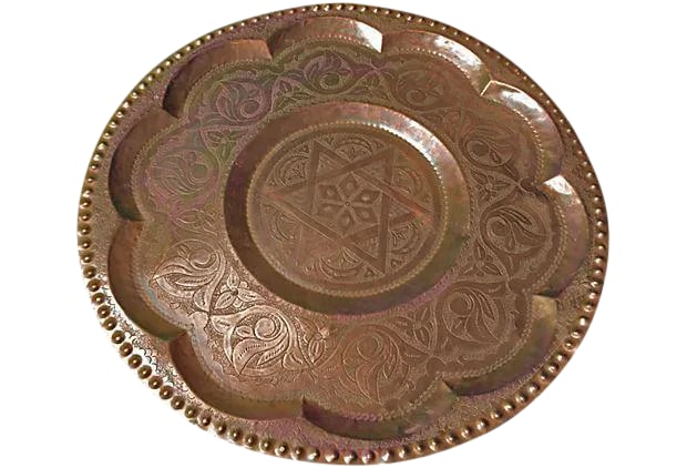 Mid 20th Century Moroccan Hand-Engraved Copper Tray: This stunning tray has been hand-hammered and engraved with elegant arabesque designs. Originally from Fez, famous for its great artisans, this tray is perfect for displaying or serving food and