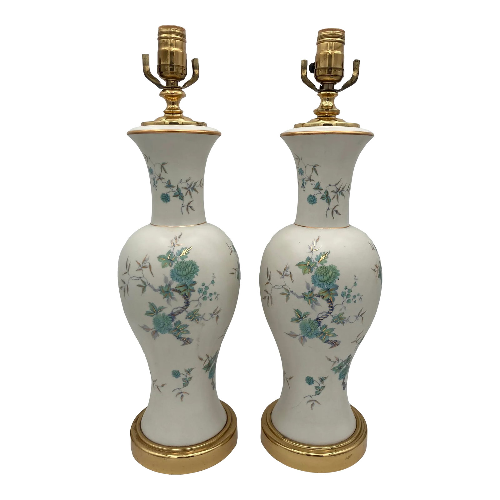 Mid-Century Japanese Porcelain Floral Table Lamps - a Pair: A pair of beautiful Japanese porcelain table lamps sit on a bright brass base and adorned with hand painted floral motif in turquoise and greens. Excludes harp, comes with two matching finials.