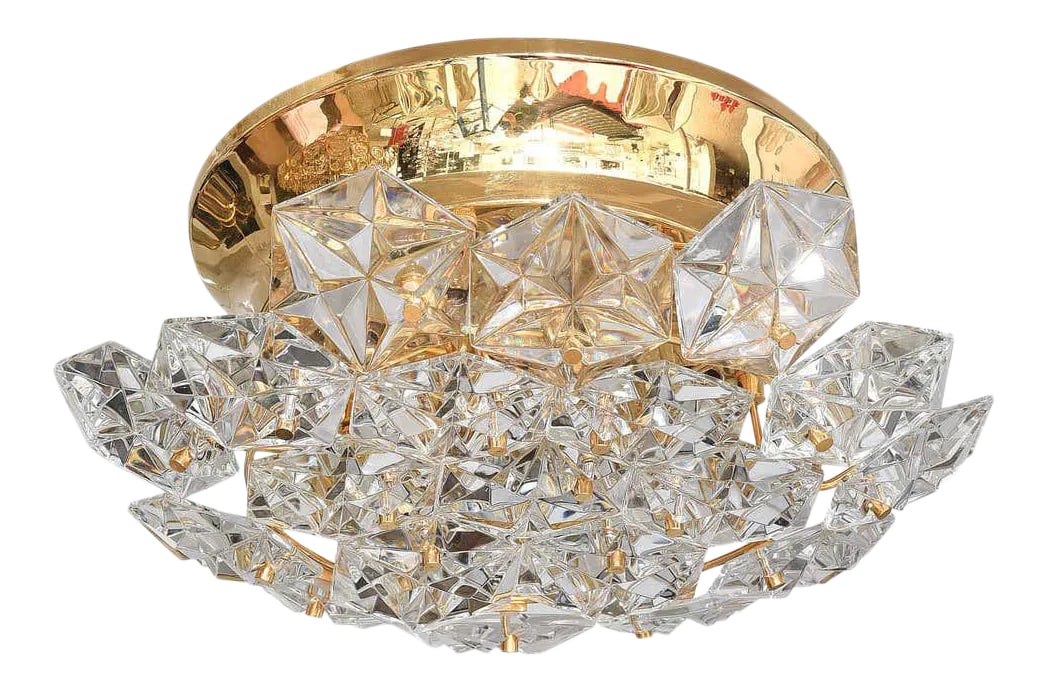 Flush Mount Chandelier by Kinkeldey: This stylish and chic chandelier definitely has the glamorous Hollywood-Regency style to it with its gold plated hardware and Northern Star motif polygon shaped prisms. It was created in the 1970s by