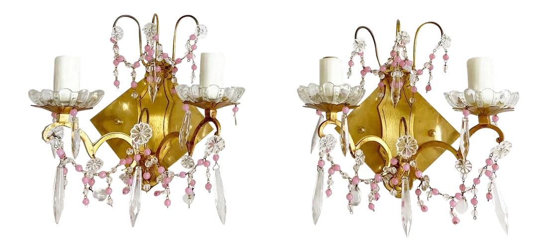 Midcentury French Crystal Sconces - a Pair: Gorgeous pair of 1960s French two-arm crystal sconces from a Paris apartment with pink opaline beading, crystal spears, drops, and rosettes topped by scalloped glass bobeches on gilded bronze frames.