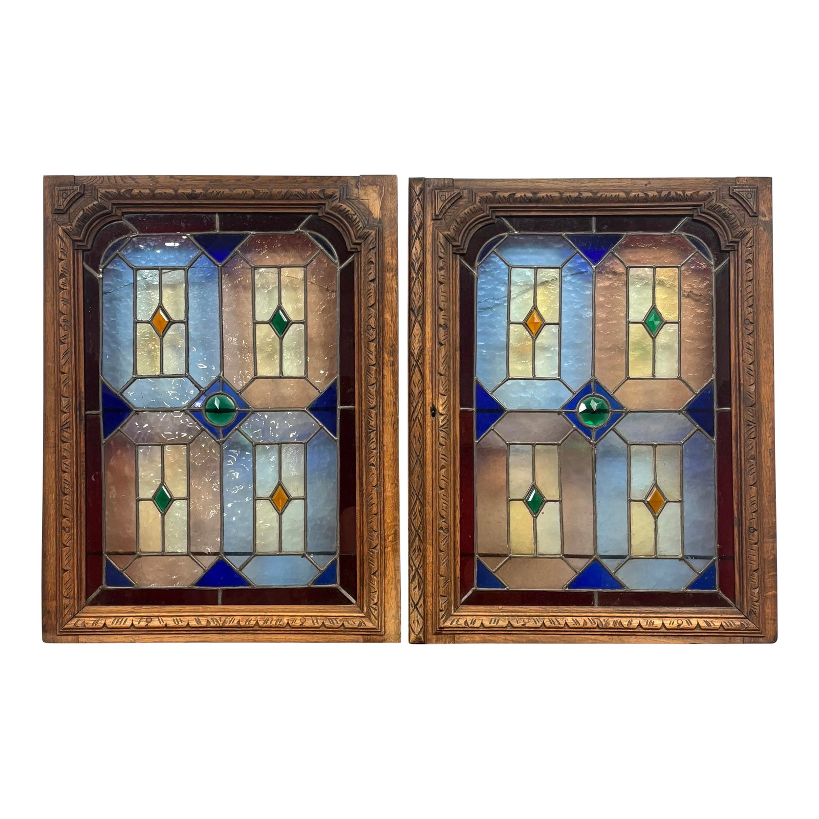 Antique Stained Glass and Wood Panels - A Pair: A stunning pair of 19th century English oak and stained glass panels, richly detailed and full of character. Each panel features beautifully carved oak framing, showcasing the craftsmanship and artist