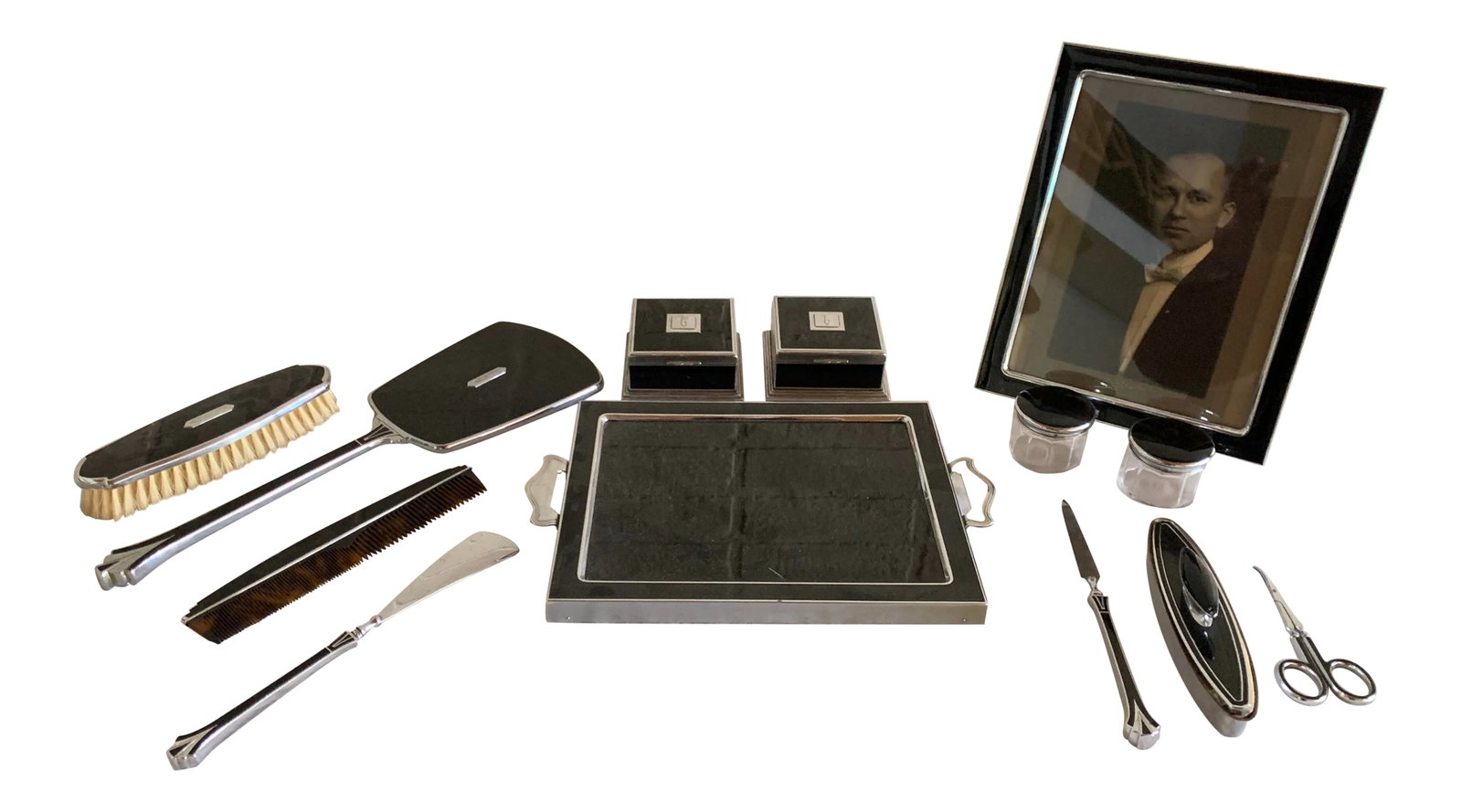 1930s Art Deco Vanity Set, 13 Pieces: Extraordinary stainless steel and enamel vanity set including frame, dresser tray, manicure pieces, make-up pieces, etc,.circa 1930 Measurements are for the picture frame. Condition: Alterations: