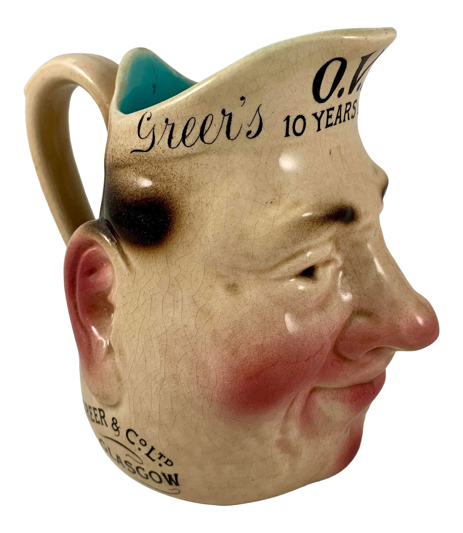French Sarreguemines Advertising Face Jug for Greer's Scotch Whiskey, 1890s: Made as a premium for the British, Scottish, and Irish pubs, and used for water when mixing a whiskey, a scarce advertising face jug. The French Sarreguemines majolica barbotine mold, Tete #3181. Tran