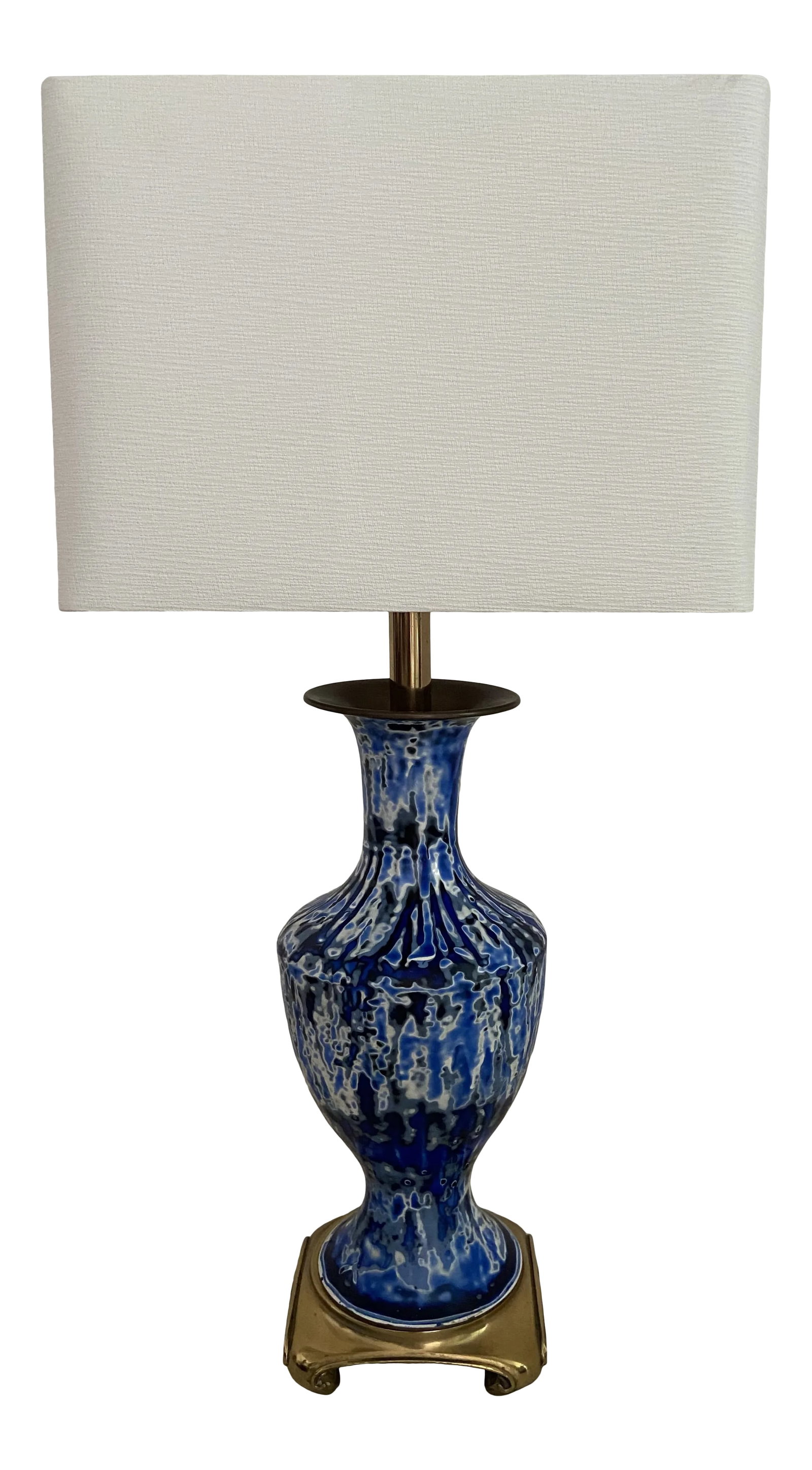 1940s Brass and Porcelain Blue Swirl Table Lamp: The lamp is a mixture of blues creating a very pretty look. The bottom is brass with Asian style feet. The well of the top is brass also. Unique in style. Condition: Alterations: Original Condition Un