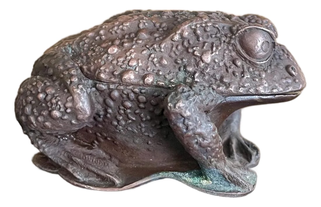 Vintage Japanese Cast-Metal Toad Trinket Box: This finely modeled Japanese cast-metal toad is both sculpture and secret keeper - a beautifully weighted lidded box disguised as a watchful amphibian. With its deeply textured skin, expressive eyes, 