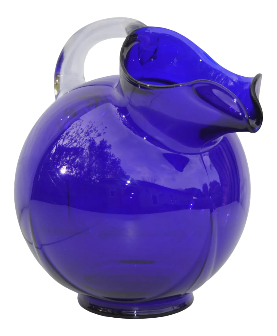 Vintage Cobalt Blue Glass Art Pitcher: Midcentury handblown cobalt blue glass vase/pitcher constructed in ornate shape with intricate base, clear glass handle and details. No maker's mark. This beautiful accent ships within 1-2 business