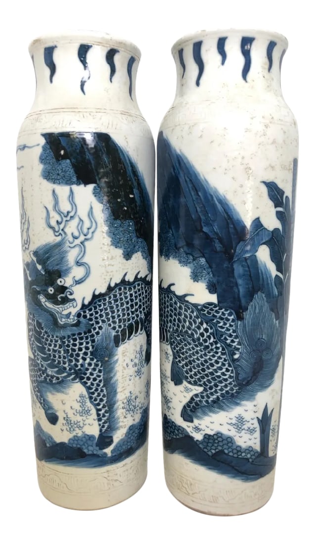 Mid 19th Century Chinese Porcelain Sleeve Vases - A Pair: Pair of Chinese porcelain sleeve vases in blue and white decorated with qilin, bearing a carved pattern at the shoulders. The qilin is a Chinese mythical hooved chimerical creature known in Chinese