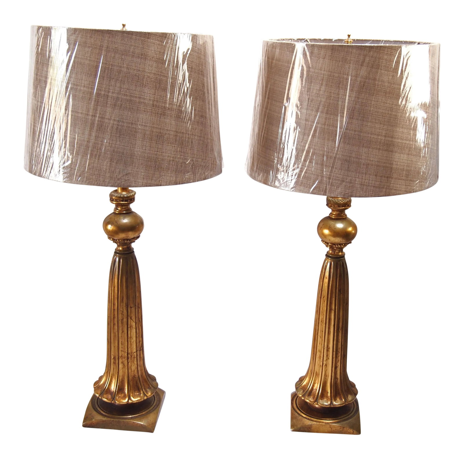 Italian Gilt Ceramic Lamps - A Pair: Lovely pair of Italian mid century gilt ceramic lamps. Fluted gilt ceramic body with with gilt wooden bases. Wired and in working condition. Includes 2 Wheat Tailor-Made brand Retro Drum style Hardbac