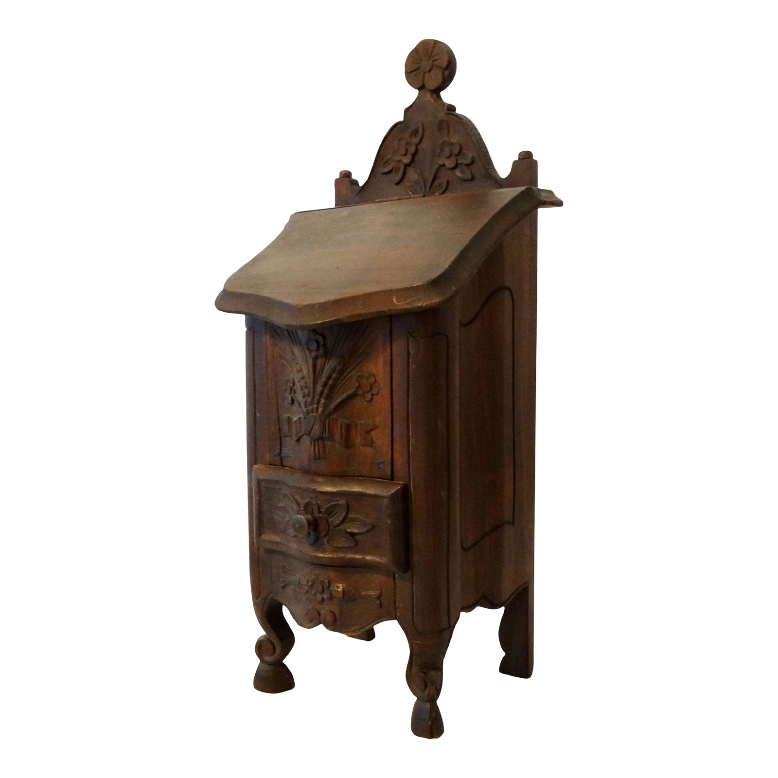 Antique Diminutive French Salt Box Table Cabinet Boite a Sel: Diminutive early 20th-Century French salt box or boite a sel table cabinet with a slanted hinged door and drawer. It is handcrafted of solid walnut and carved with a floral and leaf design, a scallope