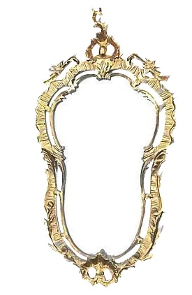 Antique Rococo Style Wall Mirror: Antique; 19th century, Rococo-style, giltwood mirror with cabochon and leaf carved crests and scrolls and leaves on the sides. No maker's mark. Condition: Very Good; minor wear. Materials: