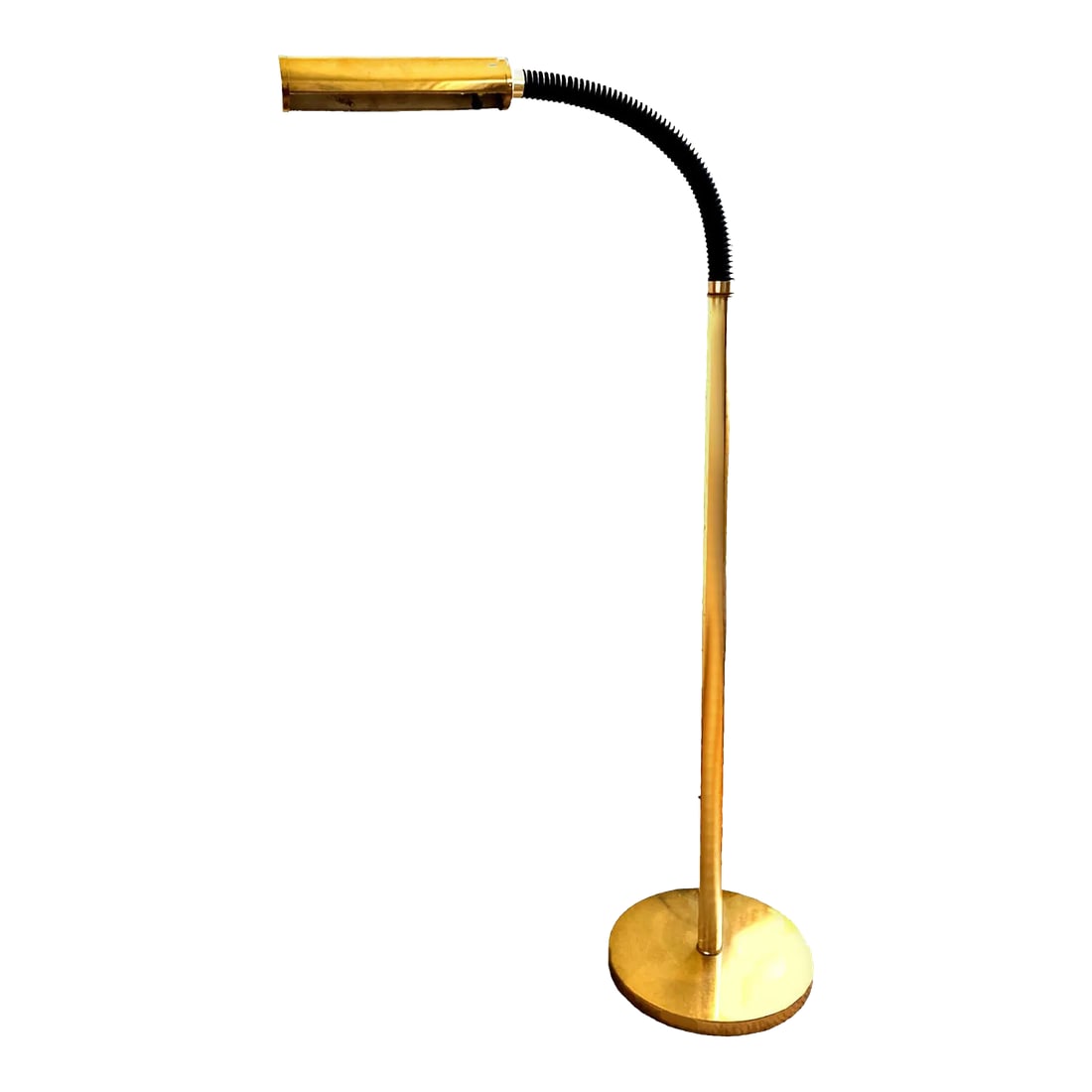 Vintage Black and Gold Toned Brass Standing Adjustable Pharmacy Floor Lamp Circa 1970s: Brass Pharmacy floor lamp with a gooseneck style arm that hosts a black sheathed accordion style sleeve at the neck. It has a rounded tube shaped brass lighting fixture that is controlled with a