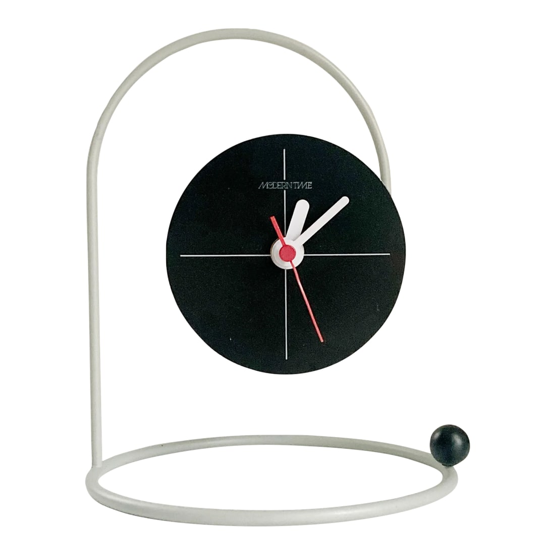 Canetti 'Moderntime' Tabletop Clock, 1980's Postmodern Clock by Nicolai Canetti: 1980s postmodern tabletop clock from Canetti Design Group is every bit as sleekly elegant as it is practical! Black face hangs as if suspended in air but is connected to a curved matte silver piece