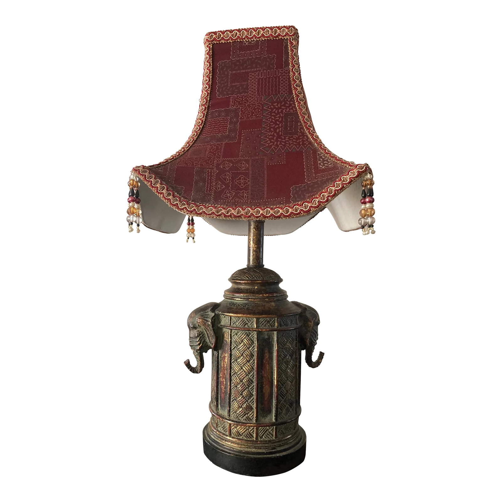 Late 20th Century Elephant Lamp: This rare lamp has a mix of Africa and Asia. Excellent used condition. The lamp has two elephant heads, one on the right and the other on the left. There is a woven rattan motif pattern engraved in wo