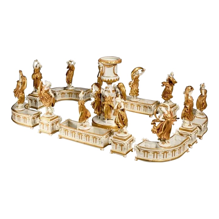 Mid 19th Century Capidemonte Italian Porcelain Surtout De Table Centerpiece in White and Gold Dancin: 19thc Italy, gilt and white glazed porcelain, (15) pieces, modeled as dancing Neoclassical beauties in flowing gowns, over cache pot modeled with rams heads and relief balustrade, central urn on