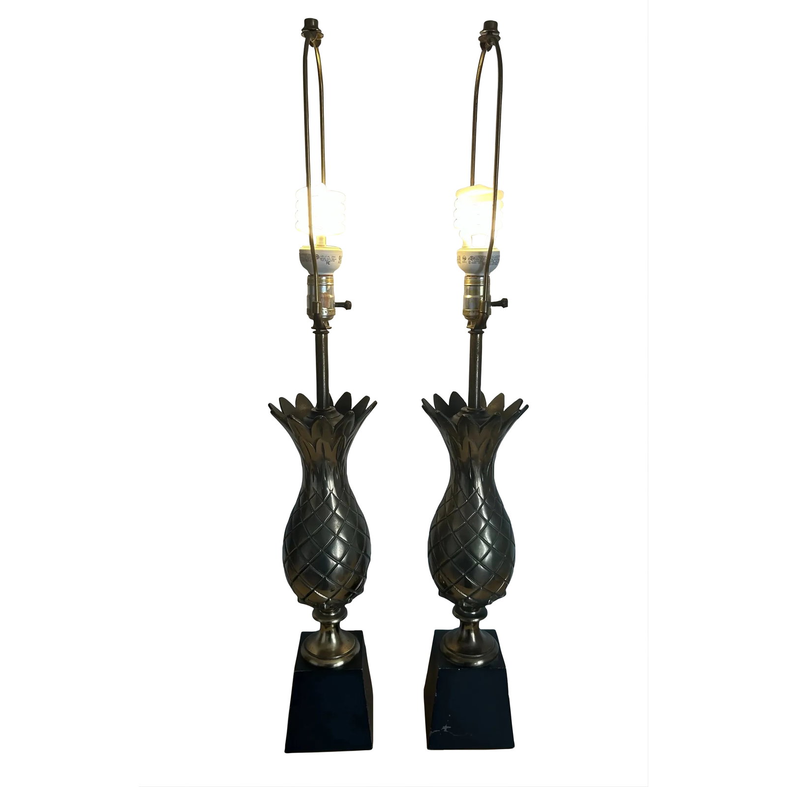 1960's Pair of Vintage Brass Figural Pineapple Table Lamps: Vintage 1960's pair of brass pineapple table lamps. Brass pineapples sit on black wood bases. Both lamps are in great working condition. Total height from base to finial is 35.5". Condition: Alteratio
