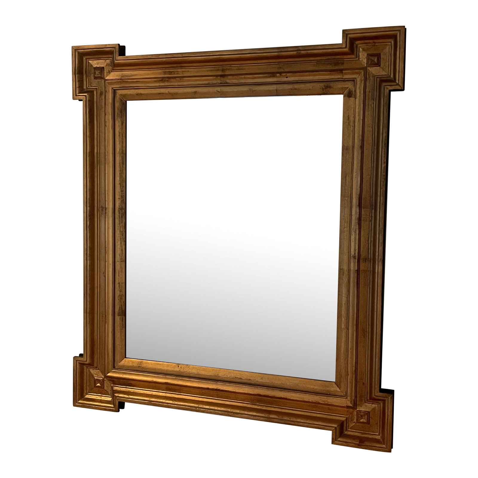 Mid-Century Gilt Mirror: Mid-Century Gilt Mirror. This framed mirror measures about 33" high, 29" wide, and 2"deep. The wood frame features a hand rubbed gilt finish with a dark undercoat and antiqued gold details. It's