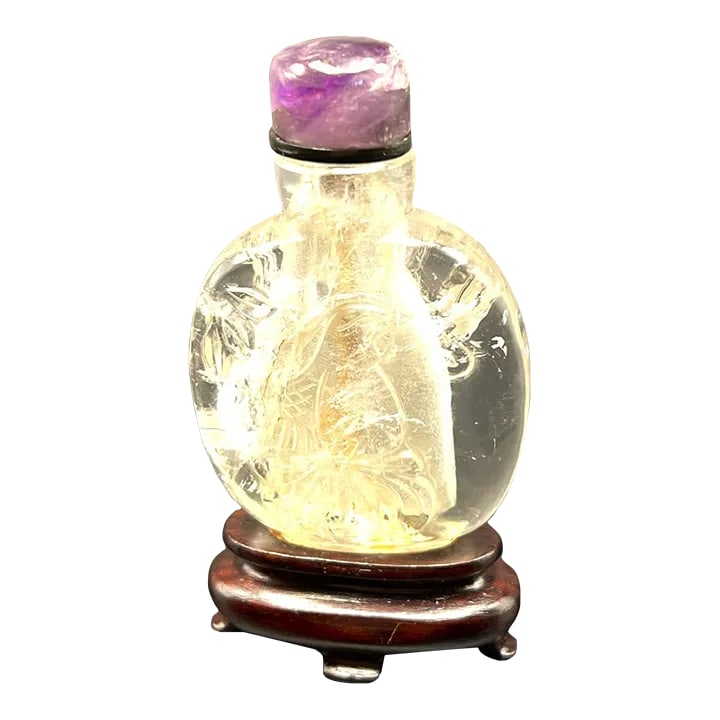 Vintage Rock Crystal Snuff Bottle With Carving and Amethyst Stopper: The rock crystal snuff bottle is a fine example of snuff bottles made during the 1950's. That was the period when Liu Shaoqi, a high ranking politican was in power, he supported and encouraged Chinese