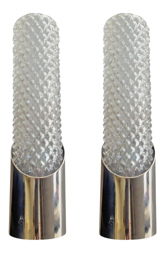 Two Pairs of German Space Age Wall Lights: A great pair of 1960s German "Space Age" sconces composed of a chrome fixture and clear crystal glass tube shades. Rewired. Two pair available. Priced per pair. Rewired. Condition: Alterations: Restor