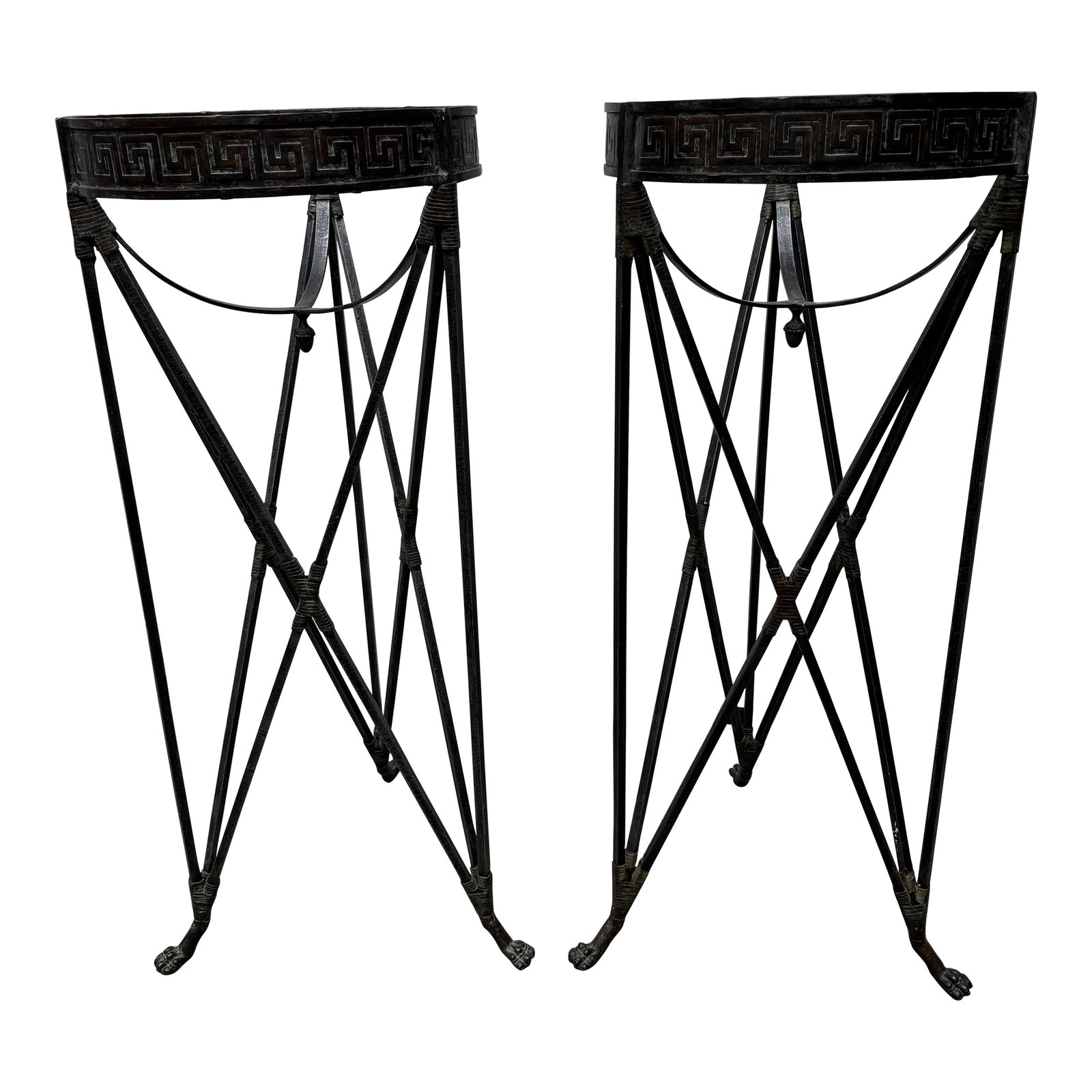 Late 20th Century Iron Greek Key Athenienne Tripod Stands - Set of 2: Listing is for a pair of Atheniennes in the French Empire style. The pair have prominent Greek Key band around the top with paw feet on tripod base. I think they've primarily been used on the inside