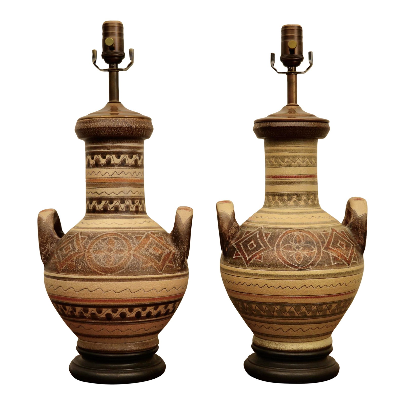 20th Century Hand Painted Pottery Lamps - A Pair: A great pairing of southwest style studio pottery lamps on turned wood bases. Although the lamps share a common urn shape, each hand painted design varies slightly in pattern and color, as well as the