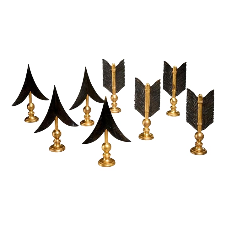 Set of 8 Arrow Head and Flight Drapery Rod Finials, 1980s: 20th c., unmarked, gilt and patinated metal, each arrowhead 7"h x 4.75"w x 1.75"d, each flight 6.5"h * 2.75"w x 1.75"d. Extremely well executed and in fine shape. Black and gold ornamentation. Mid cen